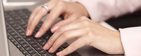 fingers typing on a keyboard